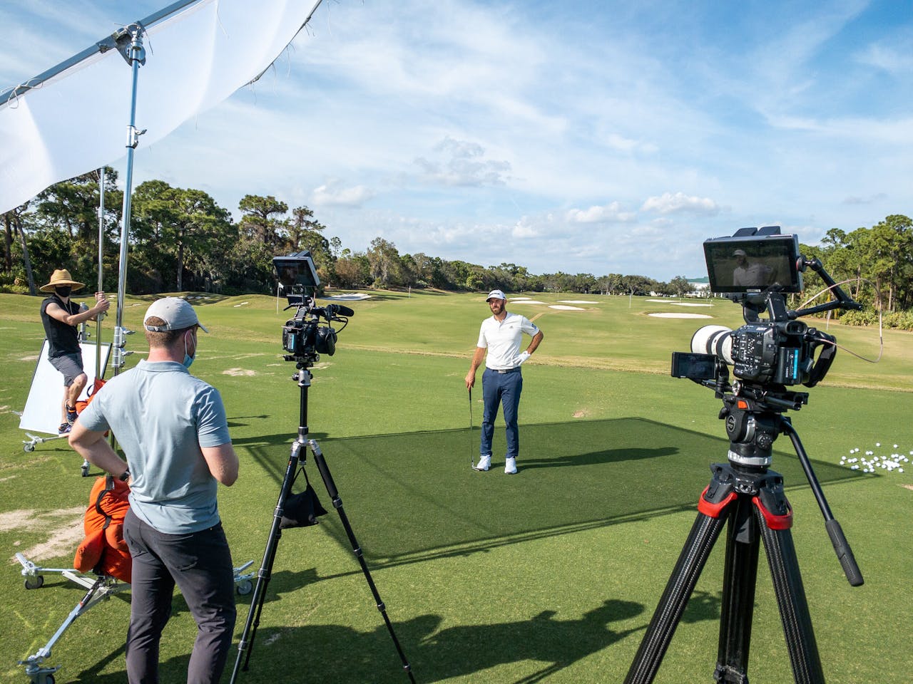 Golf video shoot on a sunny Florida course with a professional golfer and crew.